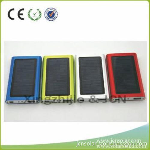 Universal solar powered battery charger for mobile phones
